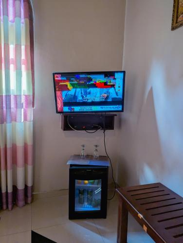 a flat screen tv sitting on top of a wall at Ella Heaven Inn in Kumbalwela
