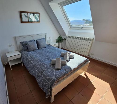 a bedroom with a bed with two towels on it at Ático Ciudadela in Jaca