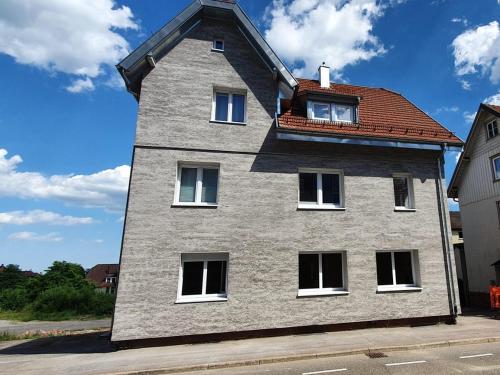 a tall gray building with a red roof at Haus Ludwig in Freudenstadt