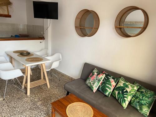 a living room with a couch and a table at Apartamentos Colomar in Es Figueral Beach