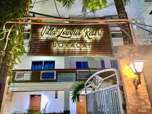 a building with a sign that reads villa junior new barcelona at VILLA LOURDES RESORT in Boracay