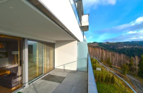 a balcony of a house with a view at Apartview Bukowa III by Rent like home in Wisła