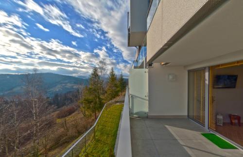 a balcony of a building with a view of the mountains at Apartview Bukowa III by Rent like home in Wisła