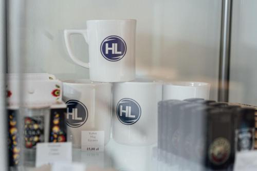 a pile of coffee cups sitting on a counter at Hotel Logos in Warsaw