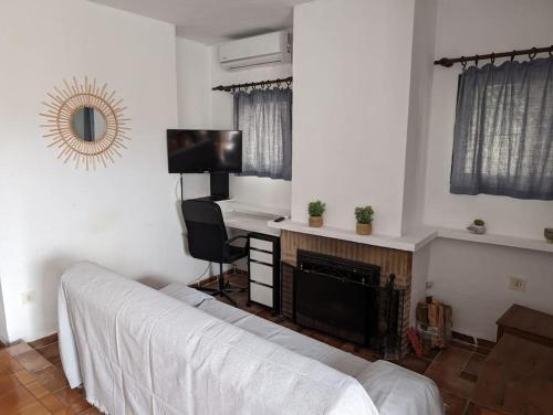 a bedroom with a bed and a desk with a computer at Casa Tere in Benitachell