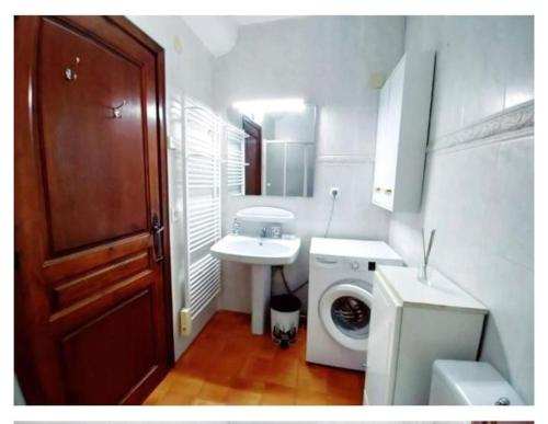 a bathroom with a sink and a washing machine at Casa Tere in Benitachell