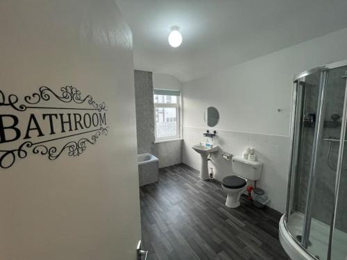 a bathroom with a shower and a toilet and a sink at Barrow Contractor Digs, Serviced Accommodation, Home from Home in Barrow in Furness