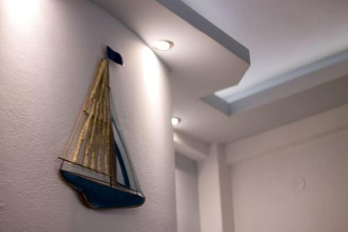 a model boat hanging on a wall in a room at Didima Apartments 1 in Pythagoreio