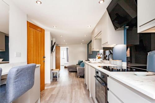a kitchen with a counter top and a living room at One bedroom apartment, Driveway, Bracknell Centre in Bracknell