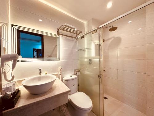 a bathroom with a sink and a toilet and a shower at REDFLOWER HOTEL in Ho Chi Minh City