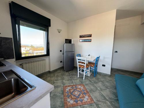 a small kitchen with a table and a refrigerator at Residence Bellavista in Manerba del Garda