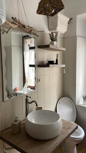 a bathroom with a sink and a toilet at Casa della Nonna in Porretta Terme