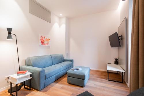a living room with a blue couch and a table at Major House - Luxury Apartments in Rome by Hostand in Rome