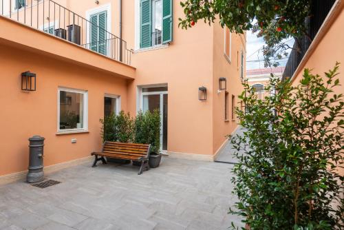a bench sitting in the courtyard of a building at Major House - Luxury Apartments in Rome by Hostand in Rome