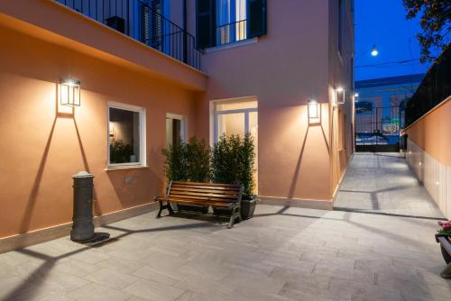 a bench sitting next to a building with lights at Major House - Luxury Apartments in Rome by Hostand in Rome