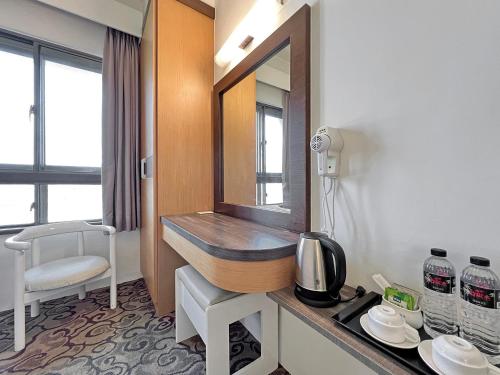 a bathroom with a sink in a hotel room at Foung Kou Hotel in Magong