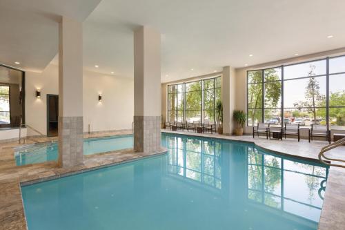 a swimming pool with blue water in a building at Embassy Suites by Hilton Phoenix Downtown North in Phoenix