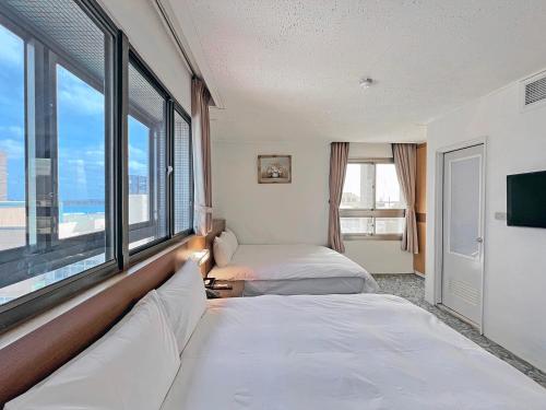 Postel nebo postele na pokoji v ubytování Foung Kou Hotel