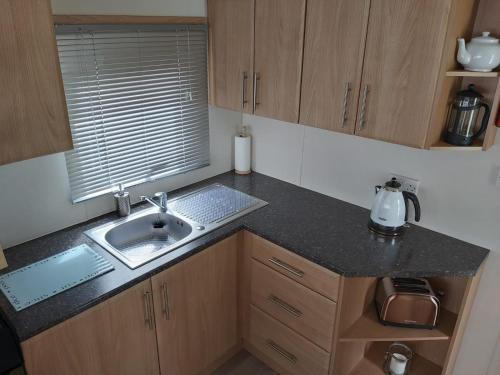 a kitchen with a sink and a counter top at Endless Summer in Barnstaple