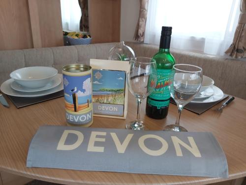a table with wine glasses and a sign that reads devonian at Endless Summer in Barnstaple