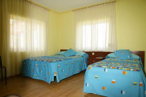 A bed or beds in a room at Hostal Residencia Delfin