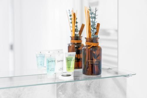 a glass shelf with a bottle of essential oils on it at New 2 Bedroom Deluxe Apartment - Parking - Wifi & Netflix - Top Rated - 50C in Sleightholme