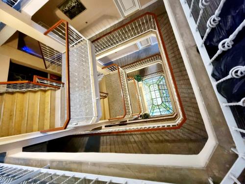 a spiral staircase with a window in a building at Perlo Hotel City in Antalya