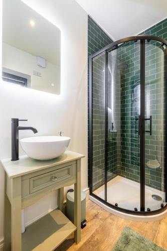 a bathroom with a sink and a shower at Boutique Stays at 78 in Bangor