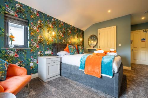 a bedroom with a large bed with floral wallpaper at Boutique Stays at 78 in Bangor