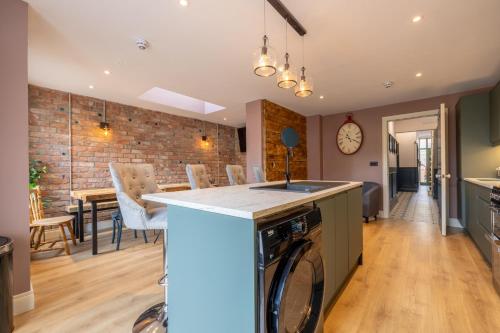 a kitchen and living room with a washer and dryer at Boutique Stays at 78 in Bangor
