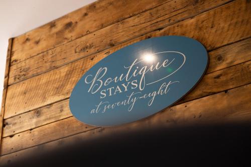 a sign on a wooden wall that reads excellence staysocial at sanctuaryitt at Boutique Stays at 78 in Bangor