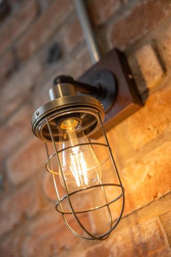 a light hanging from a ceiling with a cage on it at Boutique Stays at 78 in Bangor