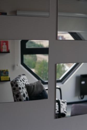 a mirror on a train with a chair and a window at Zlatibor Wild in Zlatibor
