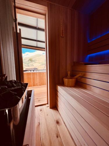a room with a sauna with a window and a tub at Zlatibor Wild in Zlatibor