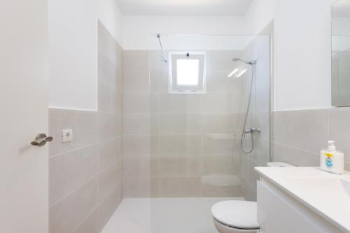 a white bathroom with a shower and a toilet at Nice Apartment in rural environment in La Orotava