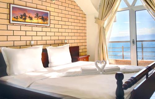 a bedroom with a bed with a large window at Royal View Villa in Ohrid