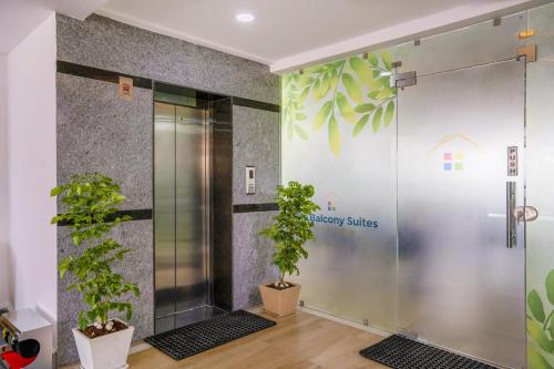 a shower stall with plants in a room at The Balcony Suites in Hyderabad