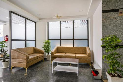 a living room with two couches and a coffee table at The Balcony Suites in Hyderabad