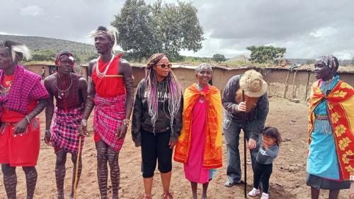a group of people standing in the dirt at Luluka Guest House in Sekenani