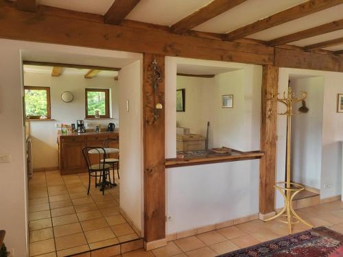 a kitchen and a living room with a table at Le GITE Du MEIERHOF in Muhlbach-sur-Munster
