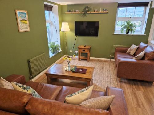 a living room with a couch and a table at The Mill in Leighton Buzzard