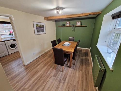 a dining room with a wooden table and chairs at The Mill in Leighton Buzzard