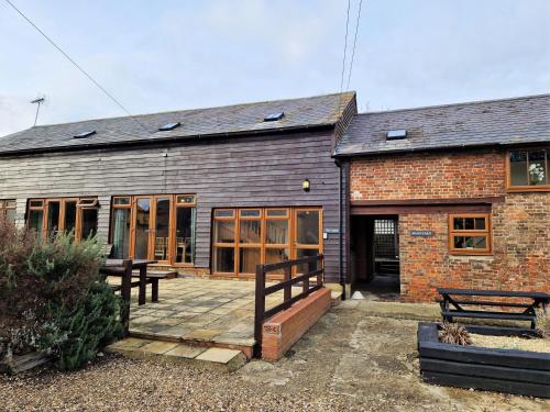 a brick building with a patio in front of it at The Dairy in Leighton Buzzard