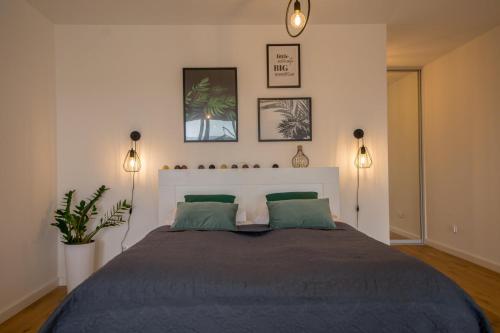 a bedroom with a large bed with two lamps at Apartview Bukowa II by Rent like home in Wisła