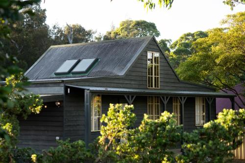 a black house with solar panels on the roof at Porpoise Palace, The South Coast Sandcastles in Huskisson in Huskisson