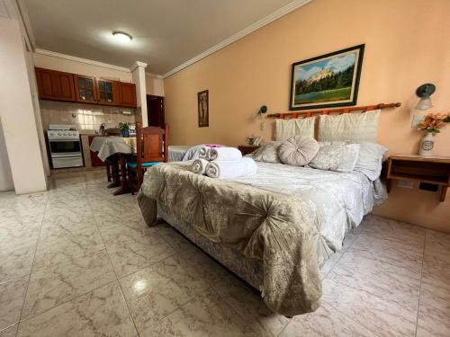 Un dormitorio con una cama grande con almohadas. en Complejo El Puente en Puerto Madryn