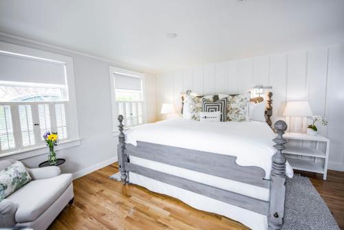 a white bedroom with a bed and a couch at The Wauwinet Nantucket in Wauwinet