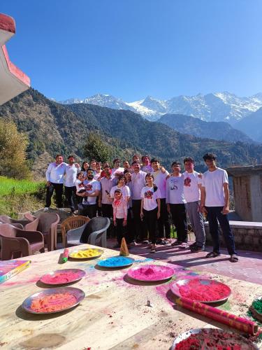 a group of people standing around a table at Kareri Wayfarer in Kareri