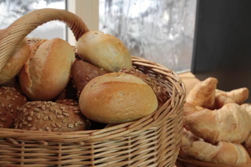
a basket filled with lots of different types of bread at Hotel Schweriner Hof in Stralsund
