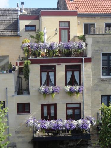 a building with flower boxes on the side of it at Appartement aan de Geul in Valkenburg